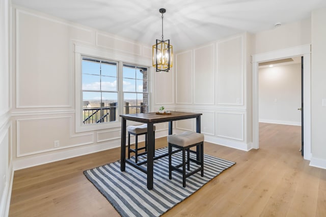 dining room featuring a notable chandelier and light wood-type flooring