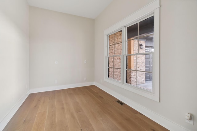 spare room with light hardwood / wood-style floors