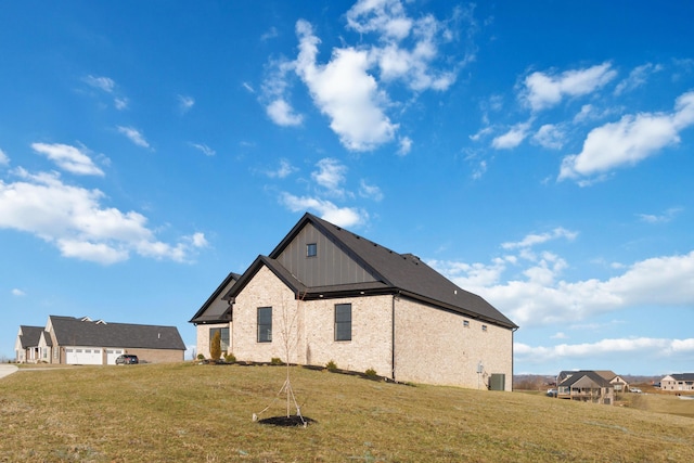 back of house featuring a garage and a lawn