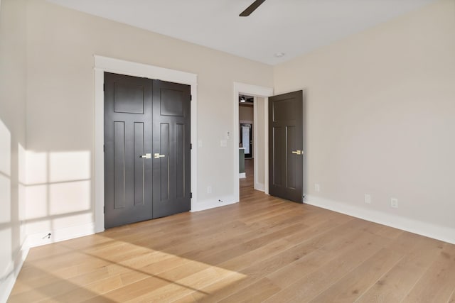 unfurnished bedroom with a closet and light wood-type flooring