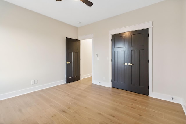 unfurnished bedroom with ceiling fan, light hardwood / wood-style floors, and a closet