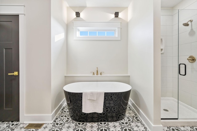 bathroom featuring tile patterned floors and independent shower and bath