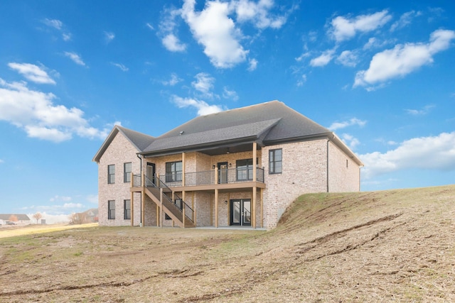 rear view of house with a wooden deck and a yard