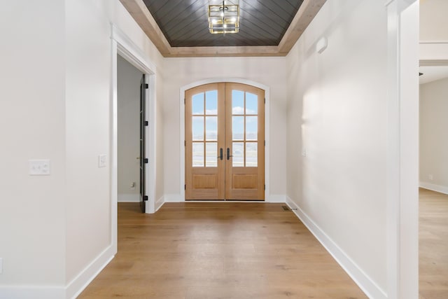 doorway featuring wood ceiling, light hardwood / wood-style floors, and french doors