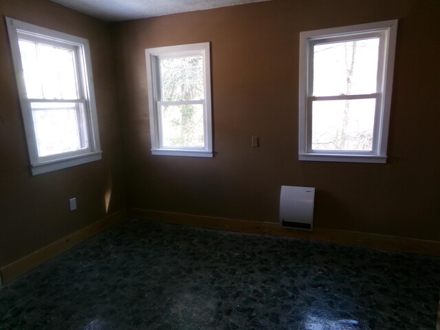 carpeted spare room with baseboards