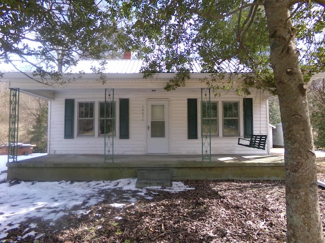 bungalow-style home featuring a porch and a chimney