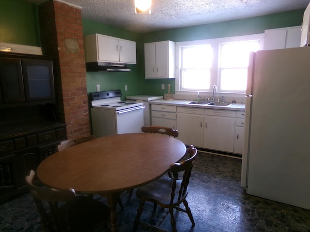 kitchen featuring light countertops, white cabinetry, a sink, white appliances, and under cabinet range hood