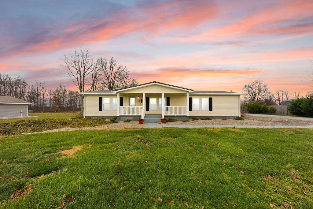 view of front of home with a lawn and a porch