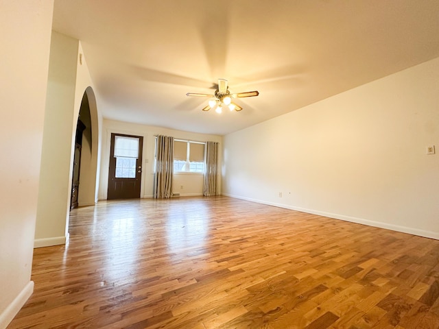 empty room featuring ceiling fan and light hardwood / wood-style flooring