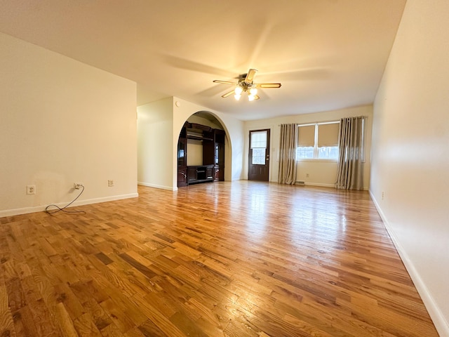 unfurnished living room featuring hardwood / wood-style floors and ceiling fan