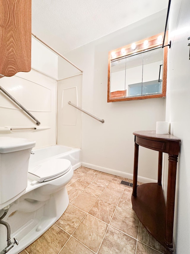 bathroom with shower / bathing tub combination, tile patterned flooring, toilet, and a textured ceiling