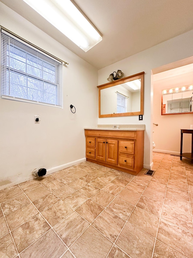 bathroom with tile patterned floors and vanity