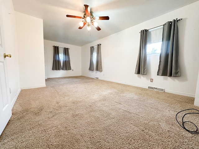 spare room featuring ceiling fan and carpet