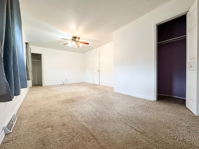 unfurnished bedroom with carpet, ceiling fan, and a closet