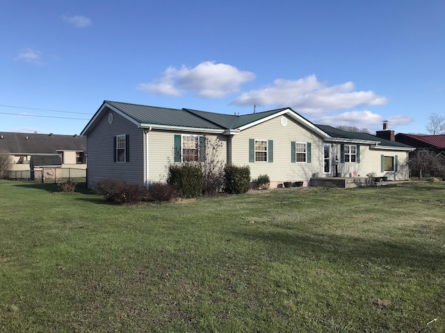 rear view of house featuring a lawn