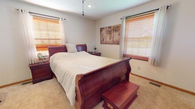 carpeted empty room featuring ceiling fan and a textured ceiling