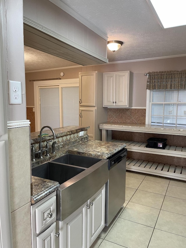 kitchen with dishwasher, backsplash, light tile patterned floors, a textured ceiling, and ornamental molding