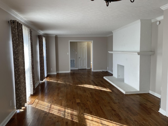 unfurnished living room with a textured ceiling, crown molding, and dark wood-type flooring