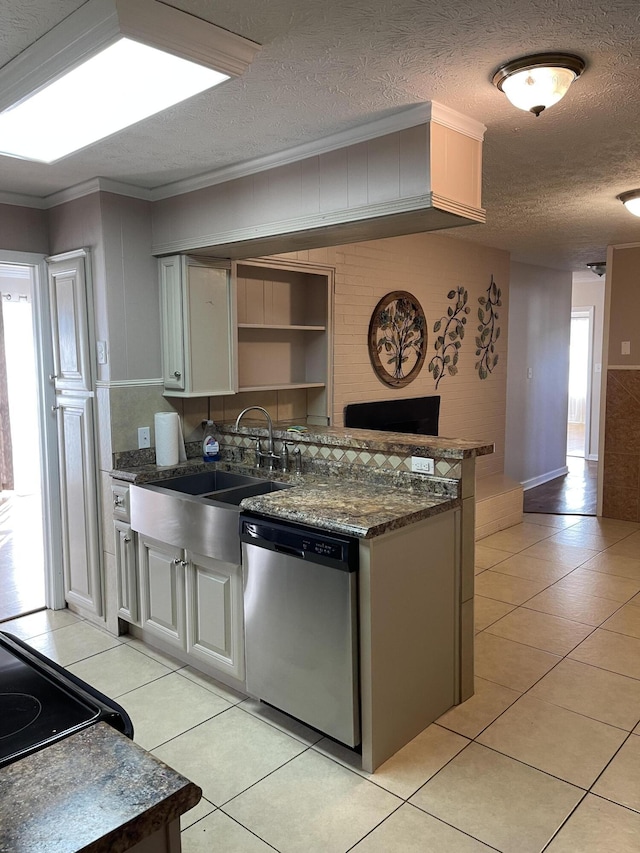 kitchen with ornamental molding, a textured ceiling, light tile patterned flooring, stainless steel dishwasher, and a sink