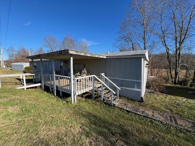 exterior space with a lawn and a wooden deck