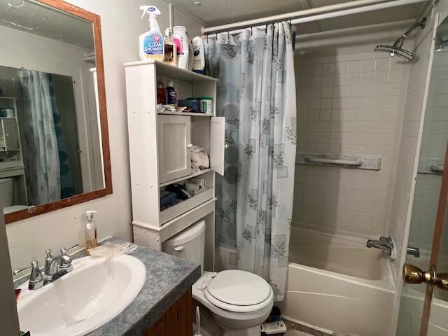 full bathroom with vanity, toilet, and shower / tub combo with curtain