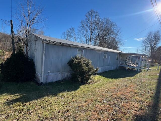 view of side of property with a lawn