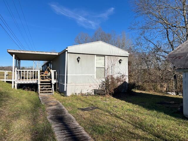 exterior space with a lawn and a deck