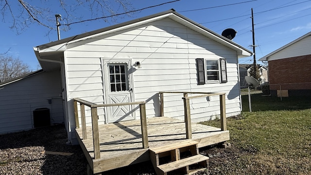 back of house with a yard and a wooden deck