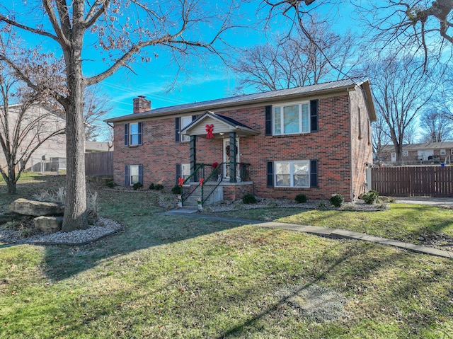 split foyer home with a front lawn