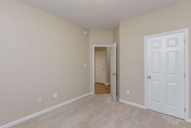 unfurnished bedroom featuring light carpet