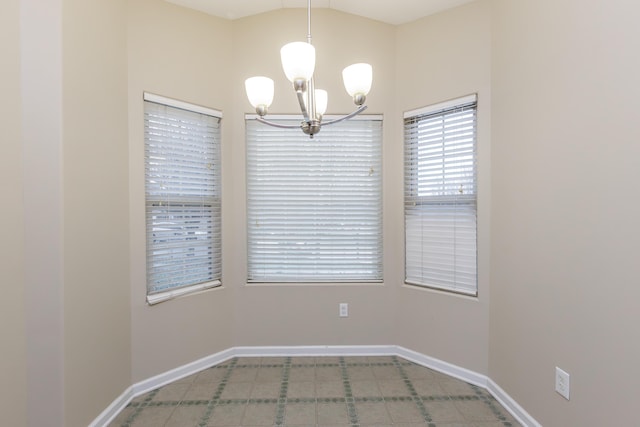 unfurnished room featuring a notable chandelier