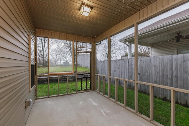 unfurnished sunroom featuring ceiling fan