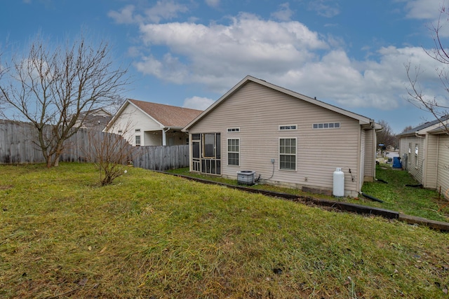 back of house featuring a lawn