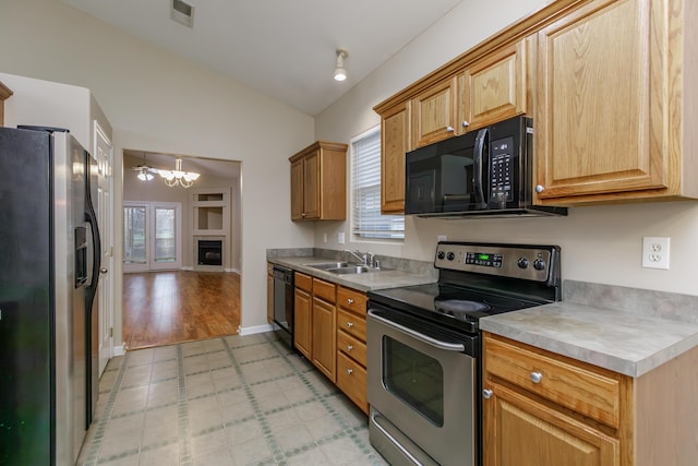 kitchen with a chandelier, sink, plenty of natural light, and black appliances