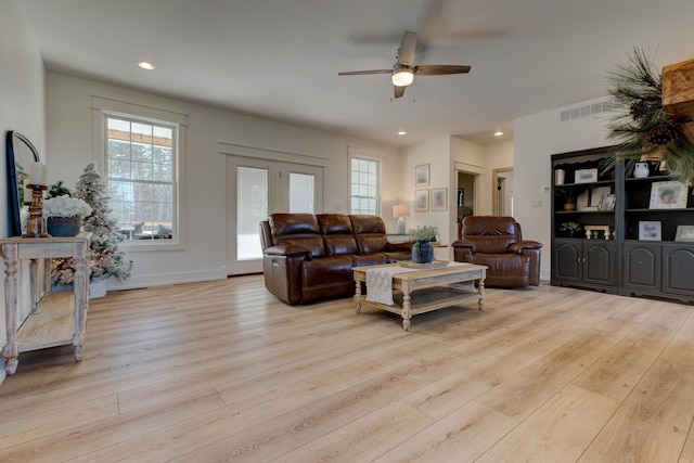 living room with ceiling fan and light hardwood / wood-style floors