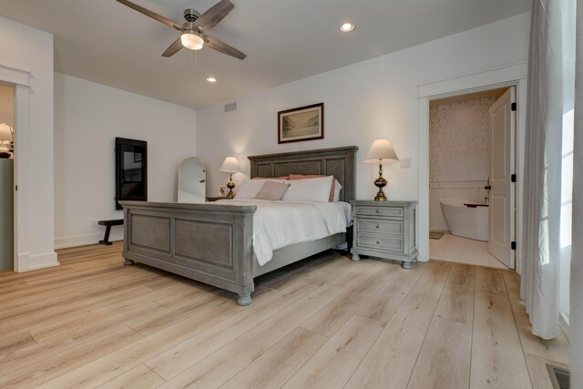 bedroom with ceiling fan, light hardwood / wood-style floors, and connected bathroom