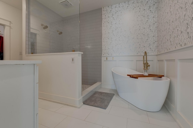 bathroom featuring tile patterned flooring and shower with separate bathtub