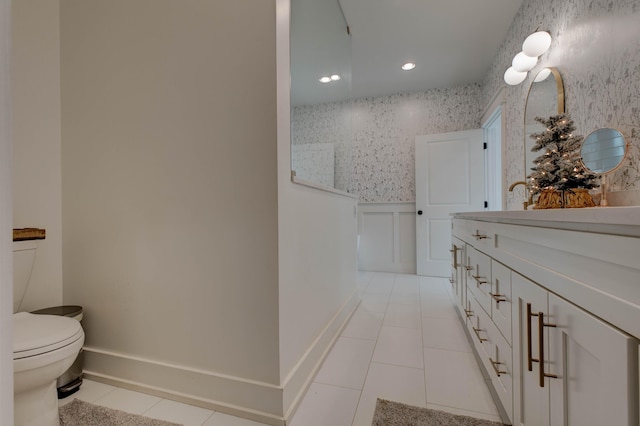 bathroom with tile patterned flooring, vanity, and toilet