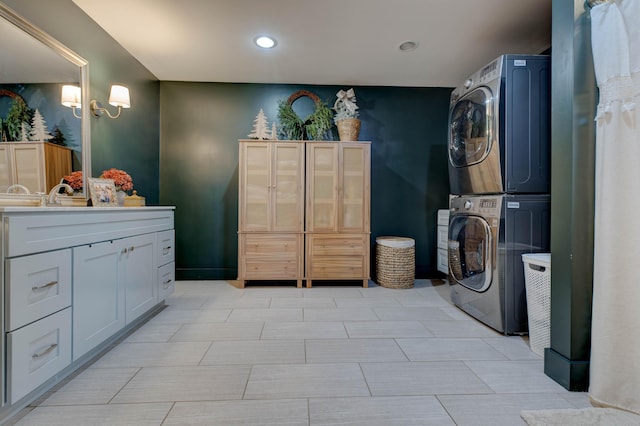 interior space with cabinets and stacked washer / dryer