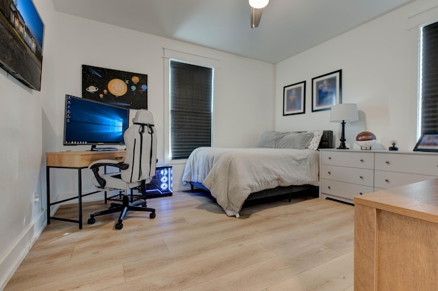 bedroom with ceiling fan and light hardwood / wood-style floors