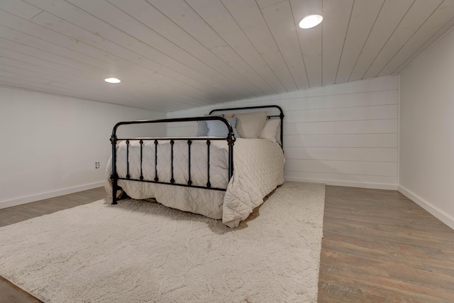 bedroom featuring lofted ceiling, dark wood-type flooring, and wood ceiling