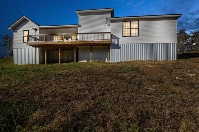 rear view of property featuring a deck