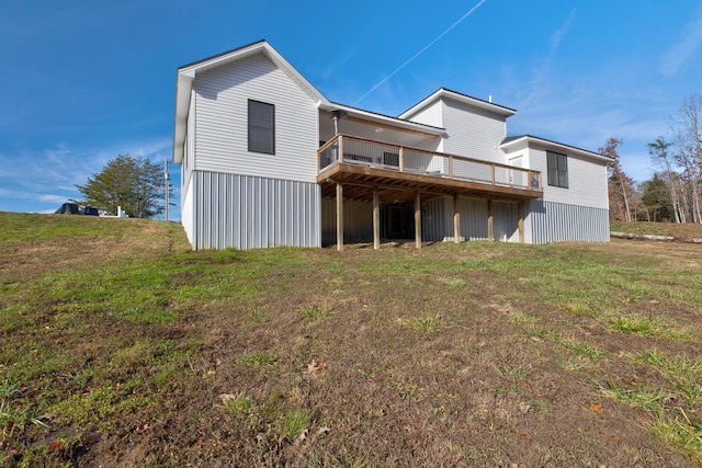 rear view of property with a lawn and a deck