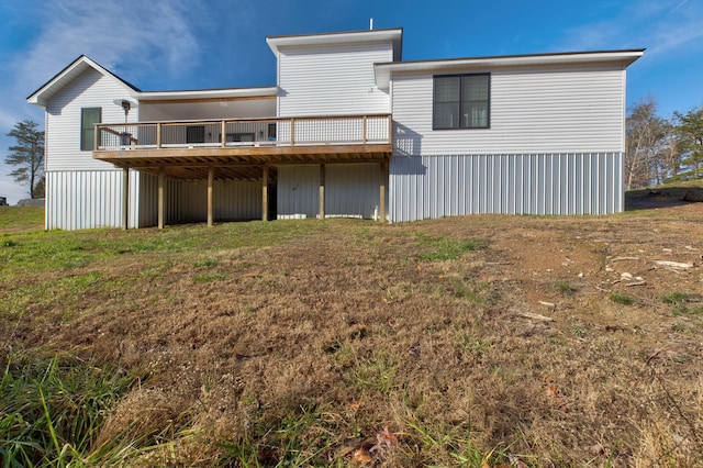 rear view of property featuring a wooden deck