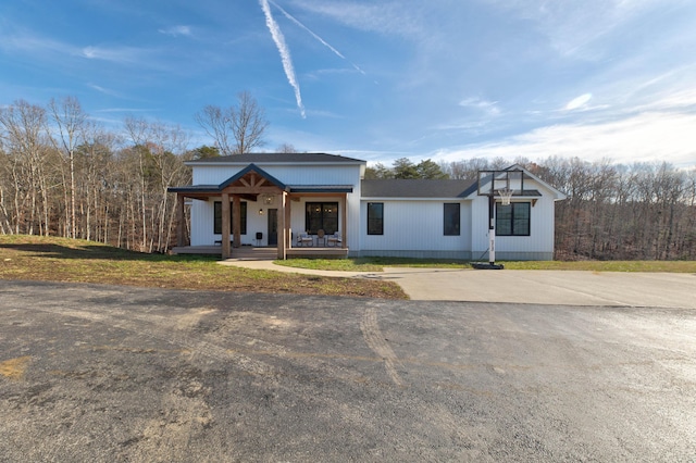 view of front of property with covered porch and a front yard