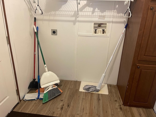 clothes washing area featuring electric dryer hookup, hookup for a washing machine, and hardwood / wood-style floors