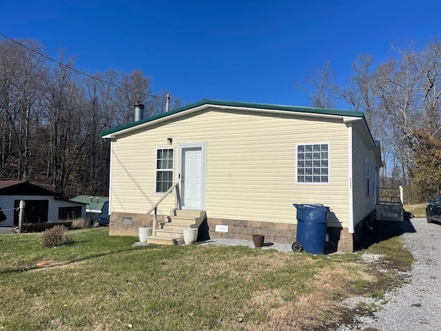 back of house with a lawn