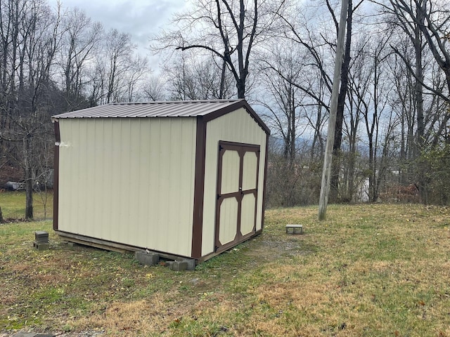 view of outbuilding with a yard