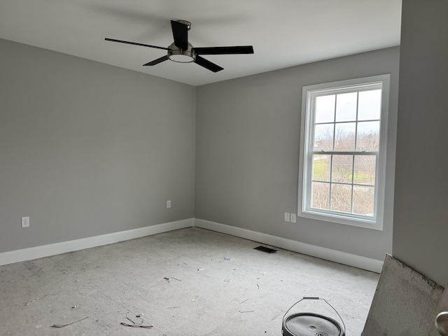 empty room featuring ceiling fan and plenty of natural light