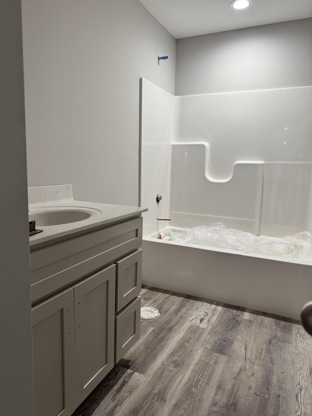 bathroom featuring vanity,  shower combination, and hardwood / wood-style flooring